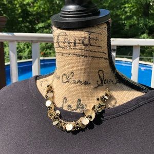 Short gold tone discs and black beads necklace